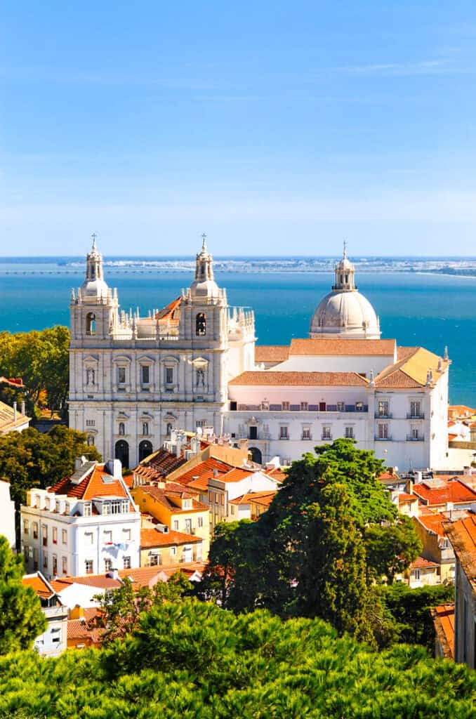 castle with water behind it in lisbon