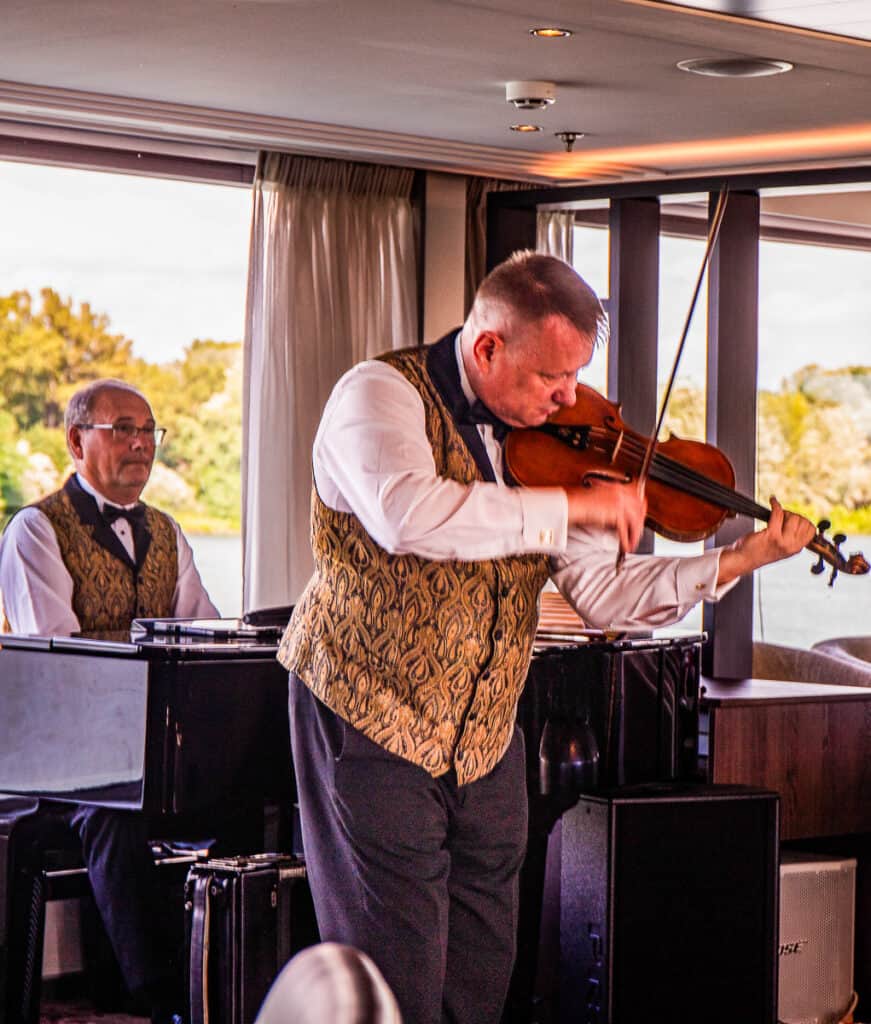 man playing violin on boat