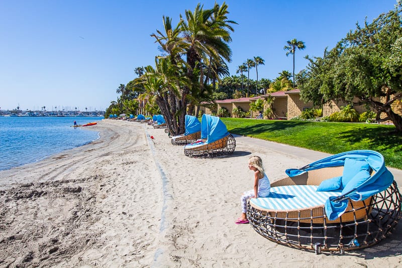 girl sitting on beach lounge in front of Bahia Resort Hotel, Mission Bay