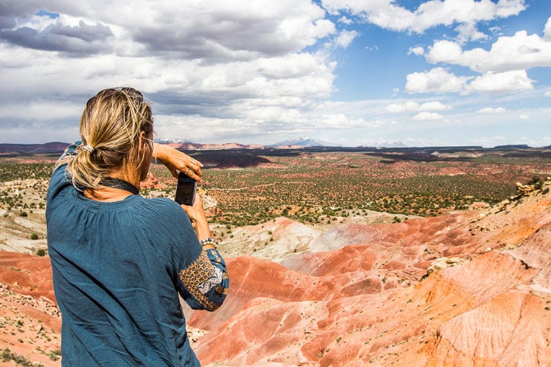 woman taking photo of view of pink cliffs
