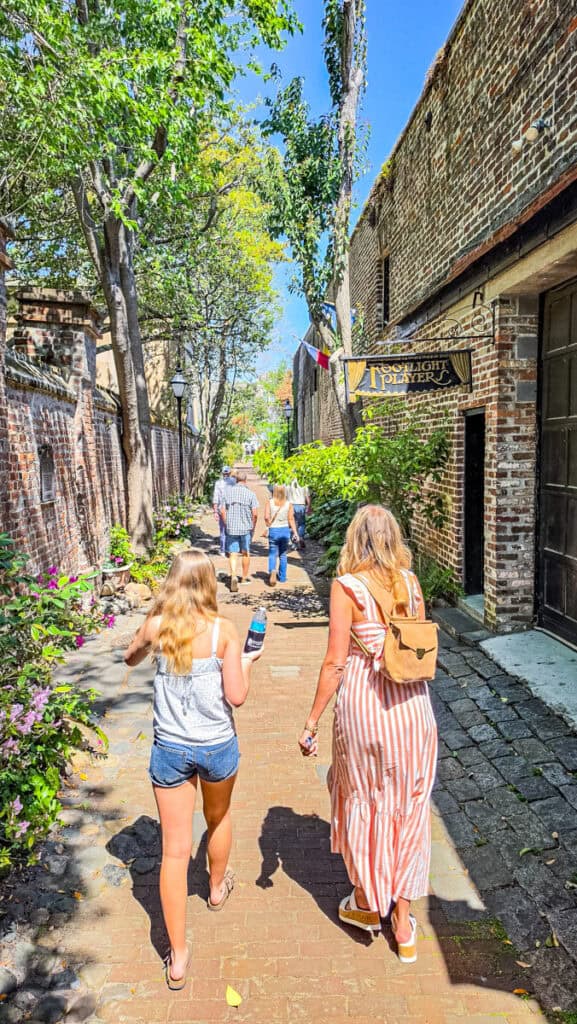 mother and child walking down philadelphia alley