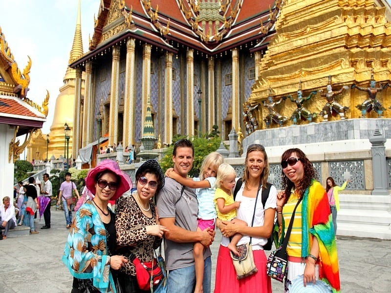 family posing outside Grand palace Bangkok