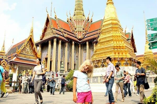 young girl standing outside grand palace in bangkok
