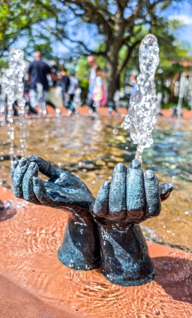 hands rising out of black american memorial fountain charleston
