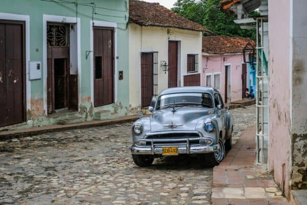old car in cuba on cobblestone street