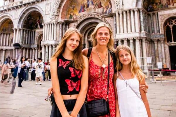 mom and daughters standing outside st mark's basilica in venice