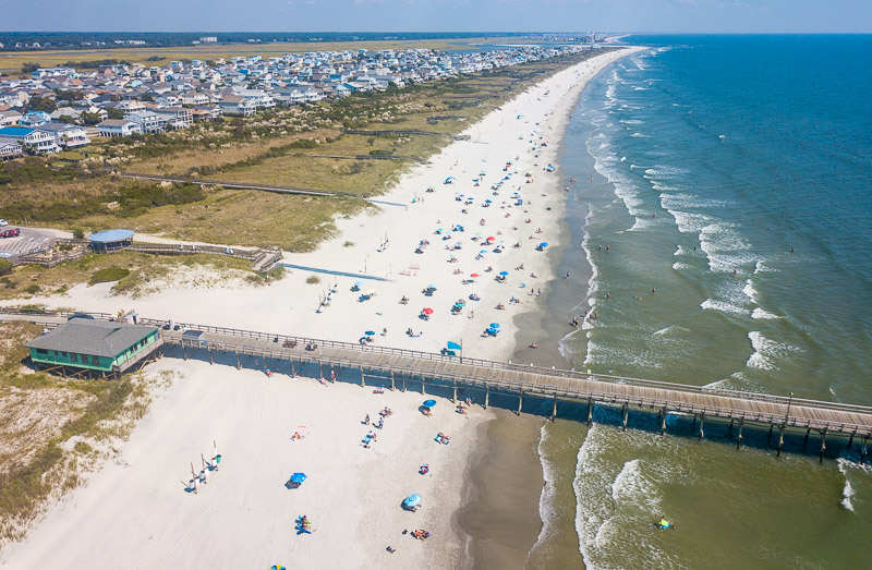 aerial of sunset beach and pier
